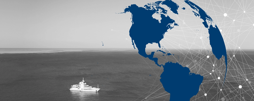 A megayacht is seen stationary at sea, with an overlay of a globe and lines signifying communication