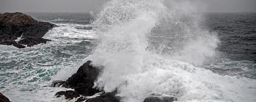 Waves crash on to a rocky coastline