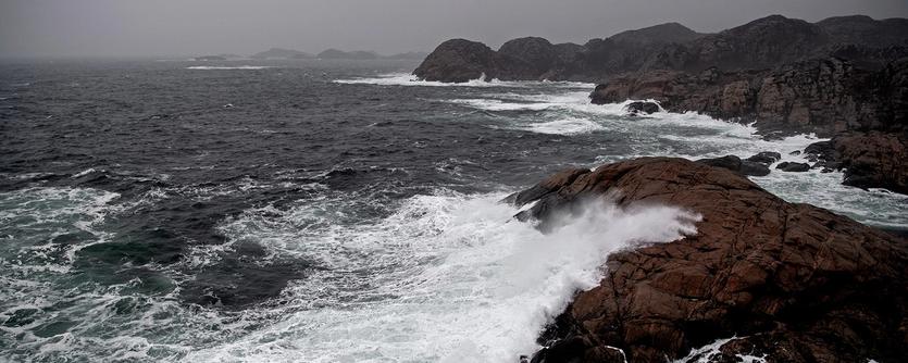 Waves crash on to a rocky shore