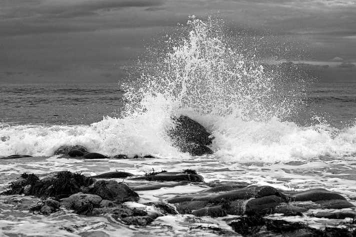 Waves crash onto a rocky shoreline