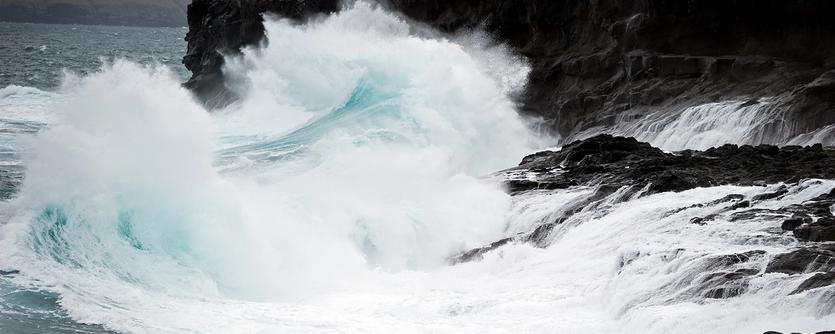 Waves crash on to a rocky coastline