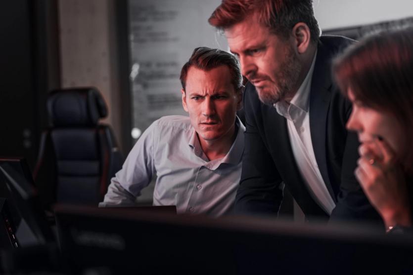 Underwriting concentrating looking at computer monitor