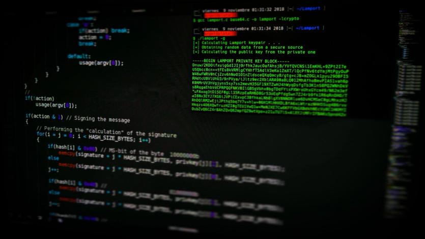 A laptop screen displaying ominous looking code