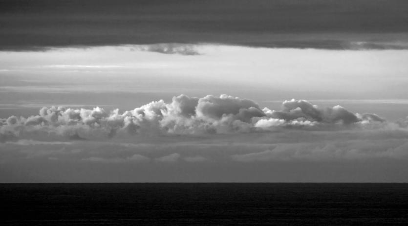A large cloud formation over a calm sea