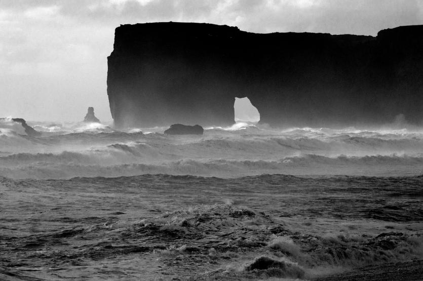 Waves crash besides a spectacular rock formation