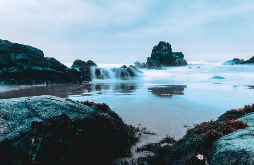 Waves crash over rocks in Supe Puerto, Peru