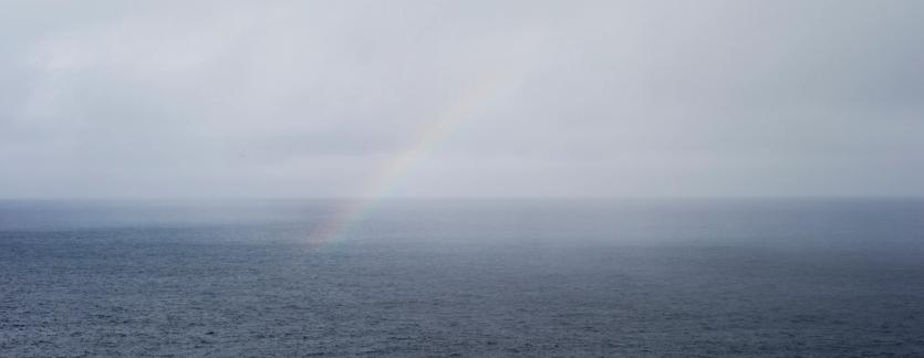 rainbow over calm sea