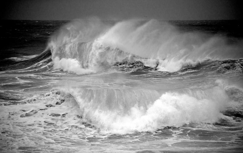 Large waves crash into the stormy sea