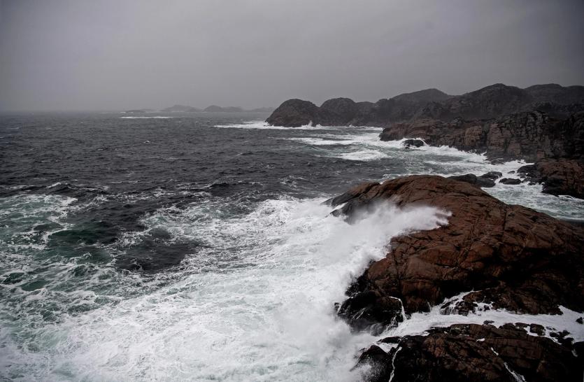 Waves crash on to a rocky shore