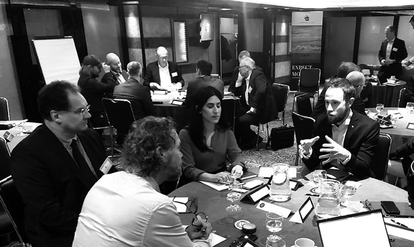 A group sits around the table in discussions at the 11th Loss Prevention Committee  