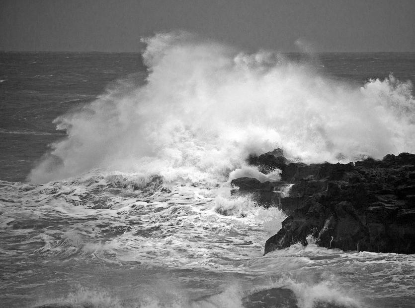Waves crash against a rocky coastline