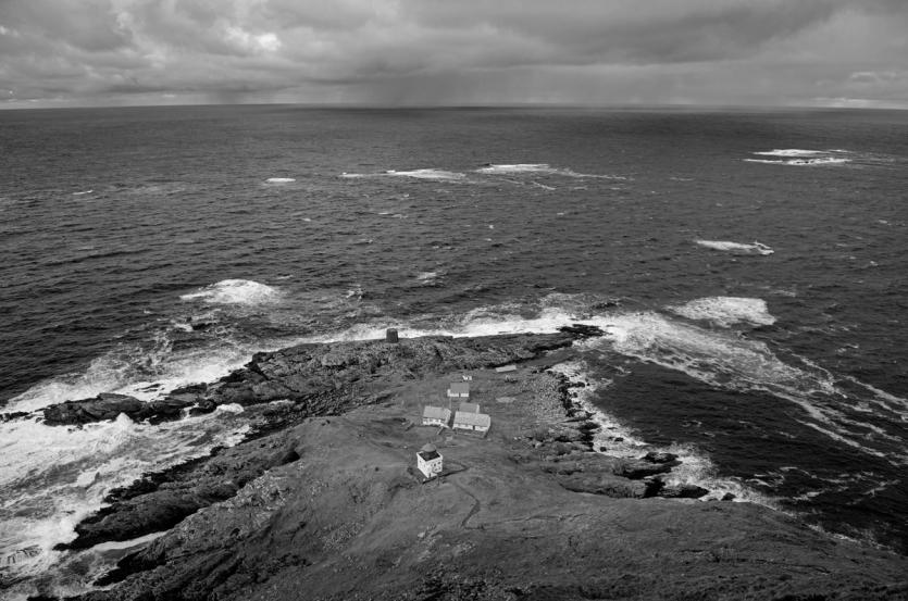 Waves crash against a rugged coastline