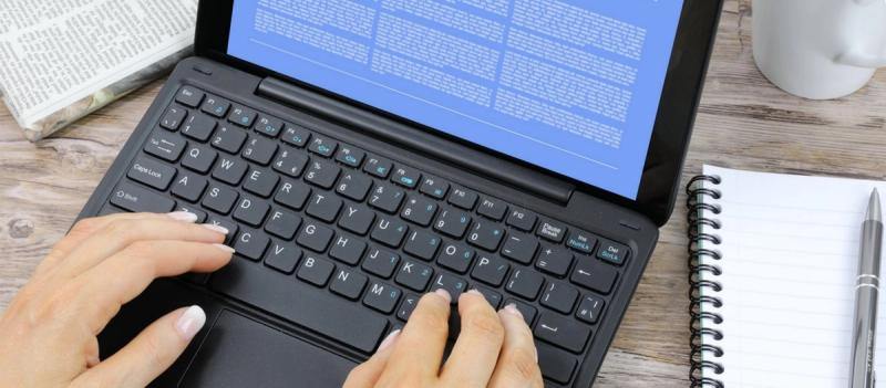 A person typing on a keyboard.