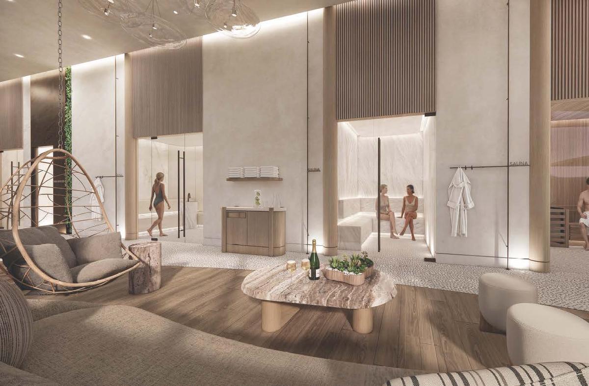 The lounge at Värra, looking through to a lit sauna where two people sit talking, with a hanging chair, a stone table set with sparkling wine, and robes on a rail.