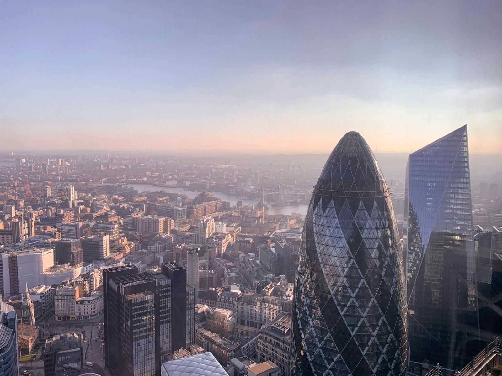 The London skyline with the Gherkin and the River Thames at low sun