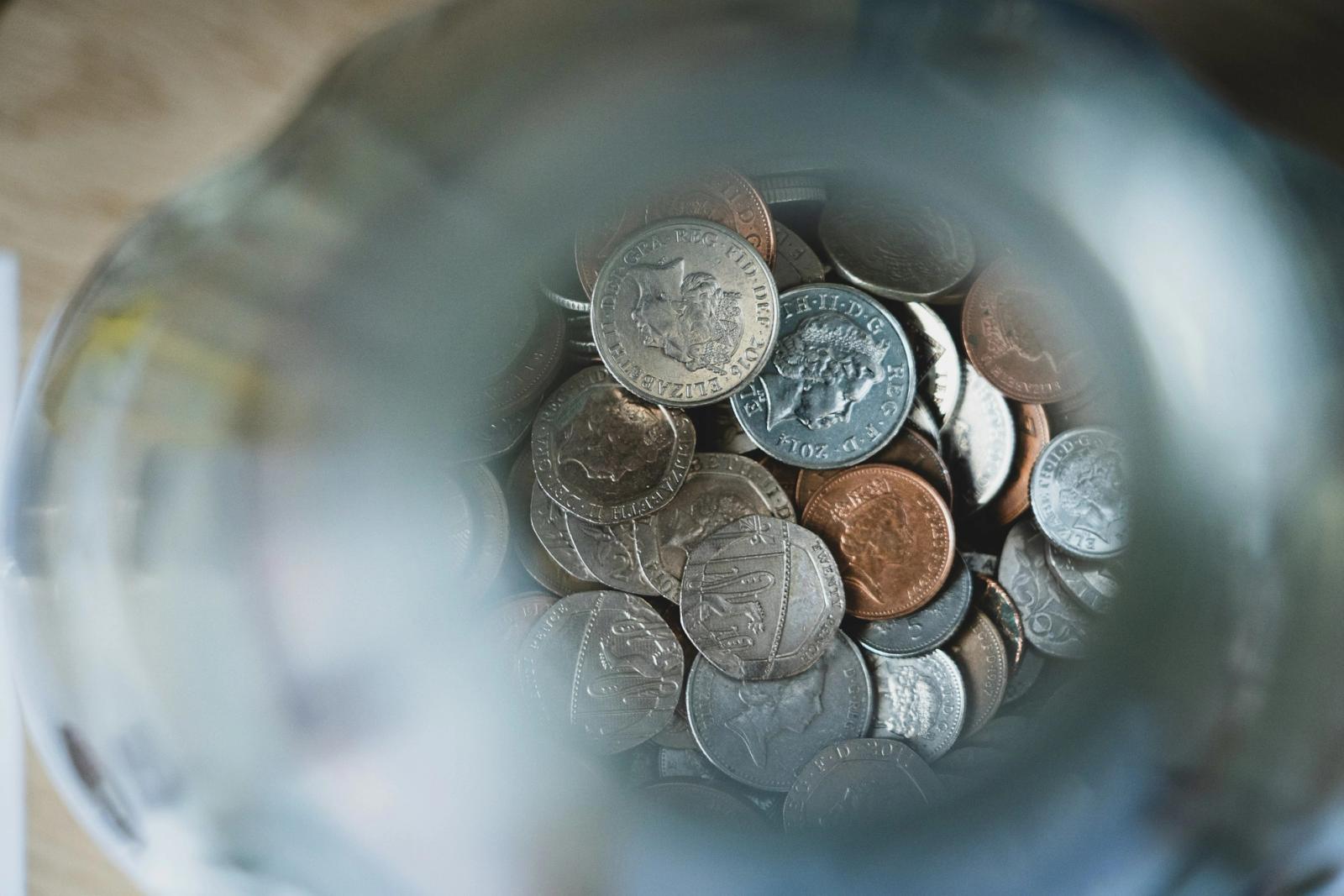 British coins in a money jar, seen from above