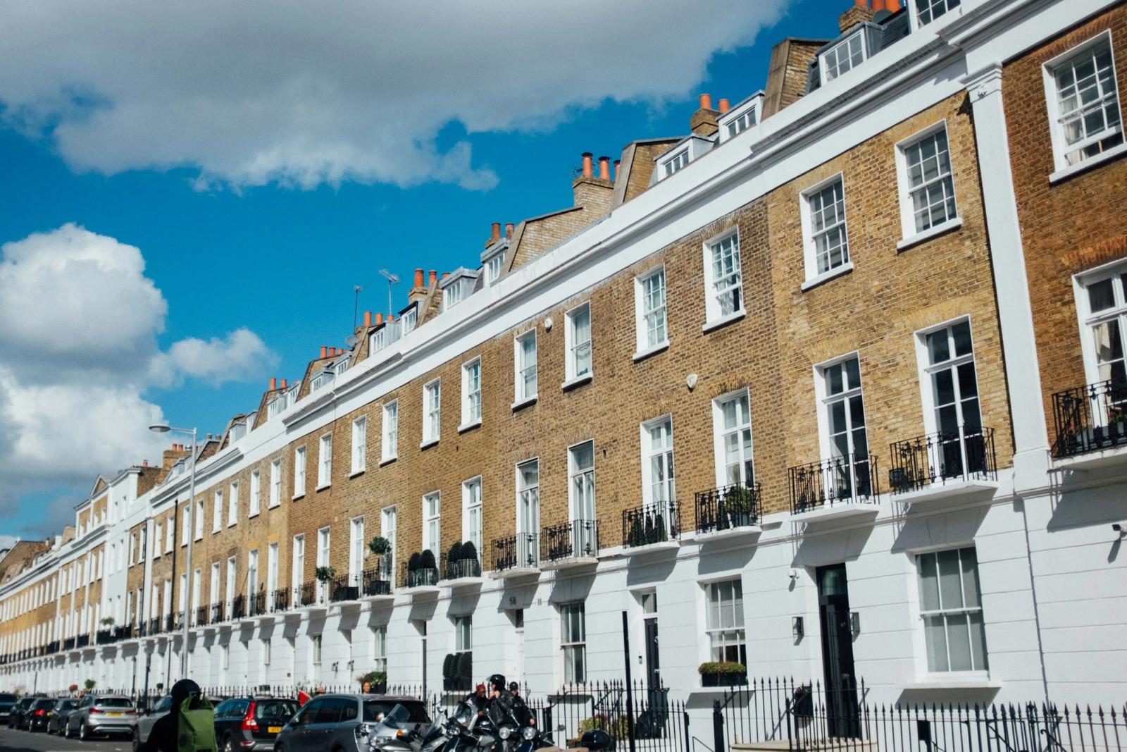 A row of terraced houses in London under a blue sky