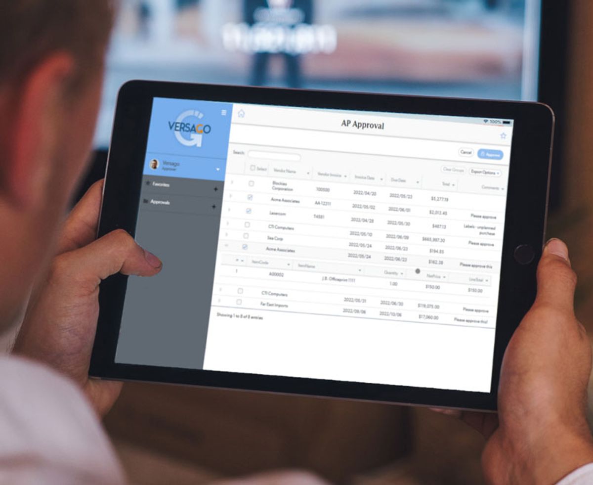 Person holding a tablet displaying an AP Approval spreadsheet-style dashboard