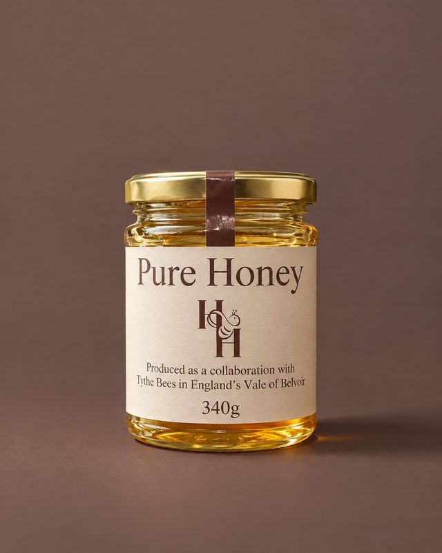 A jar of Honey & Haven Pure Honey with its cream label and gold lid