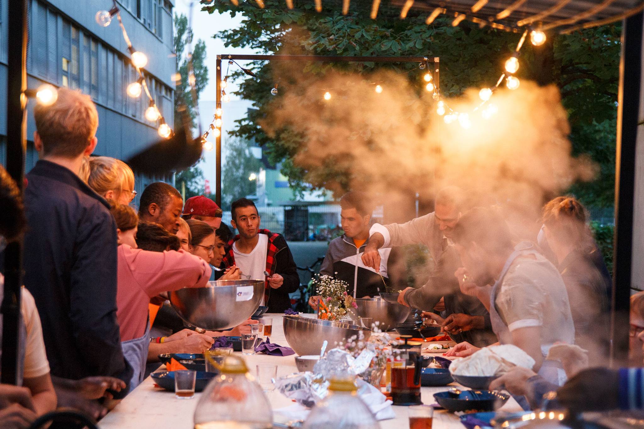 How do Berliners use local cuisine to help refugees?