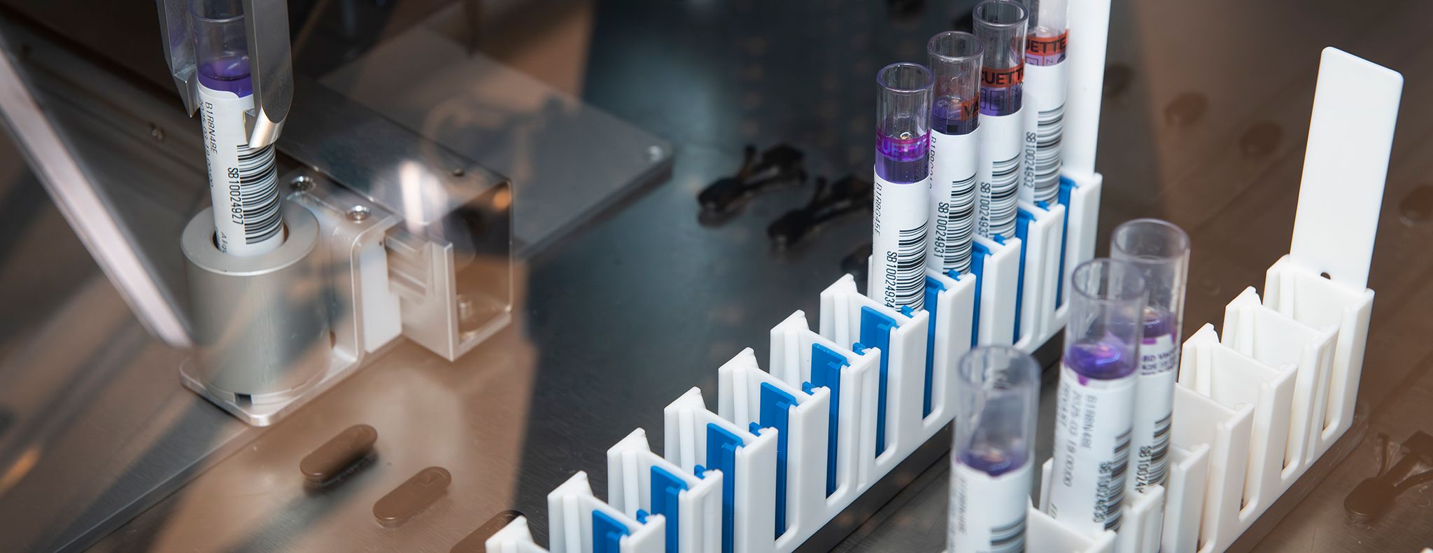 Blood sample tubes being processed in an automated laboratory analysis machine
