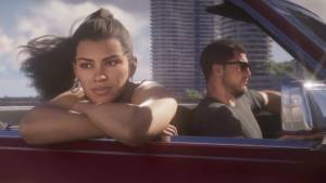 Lucia leans on the door of a red convertible while Jason drives in sunglasses, high-rises behind them.