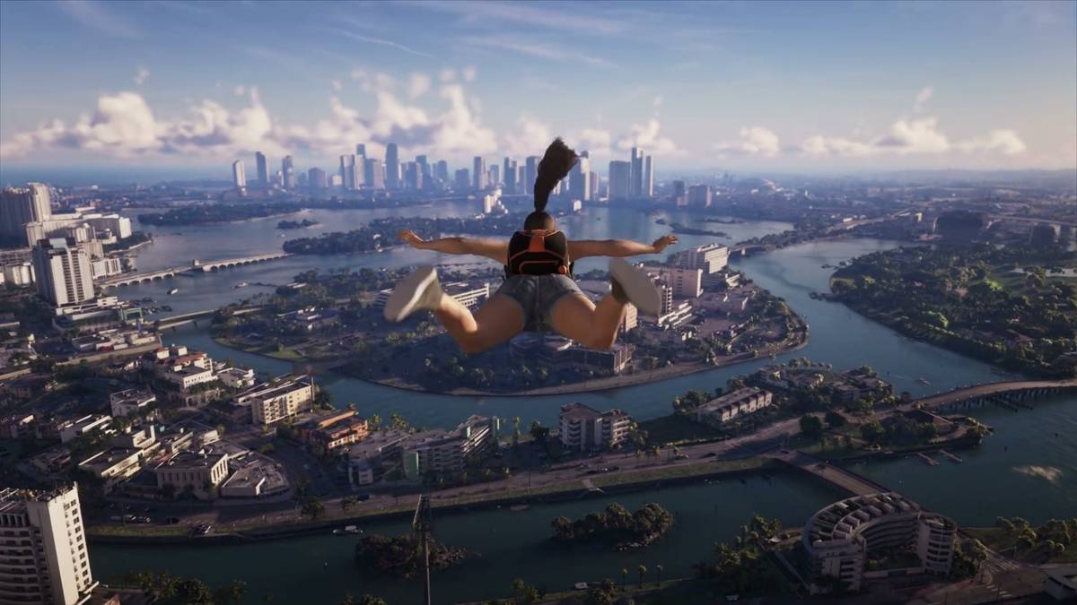 A skydiver in freefall above Vice City's islands and bridges, with the downtown skyline on the horizon.