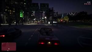Gameplay of a red convertible driving at night under highway signs for VCI Airport and Vice Beaches, with a wanted level showing.