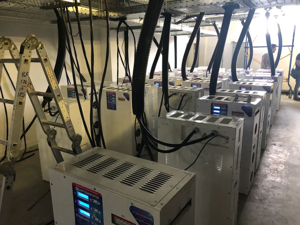 Rows of industrial electrical equipment with overhead conduits during installation