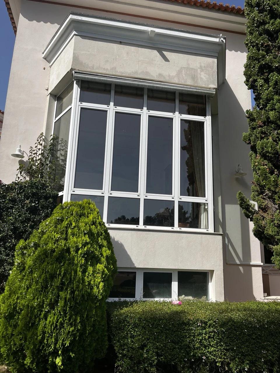 Completed multi-panel bay window installed in an existing stucco residence