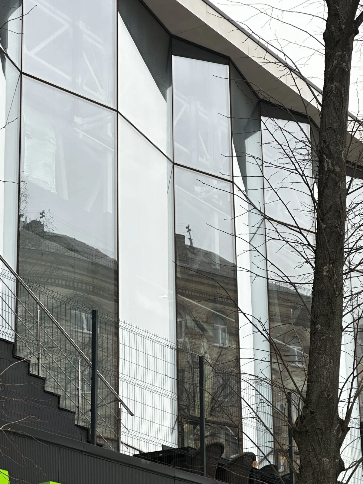 Full-height transparent commercial curtain wall with slender dark framing