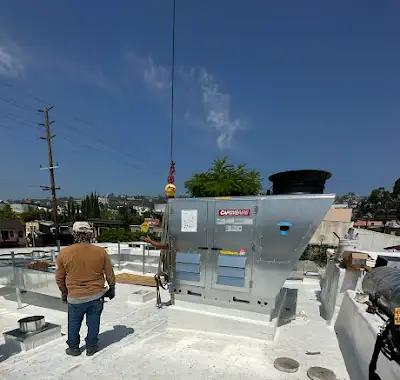 Equipo HVAC comercial siendo colocado en su posición preparada sobre la cubierta