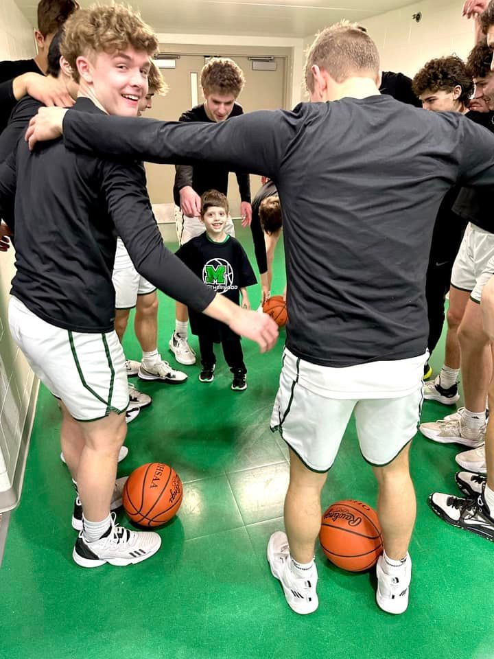 Christian in middle of MHS basketball huddle
