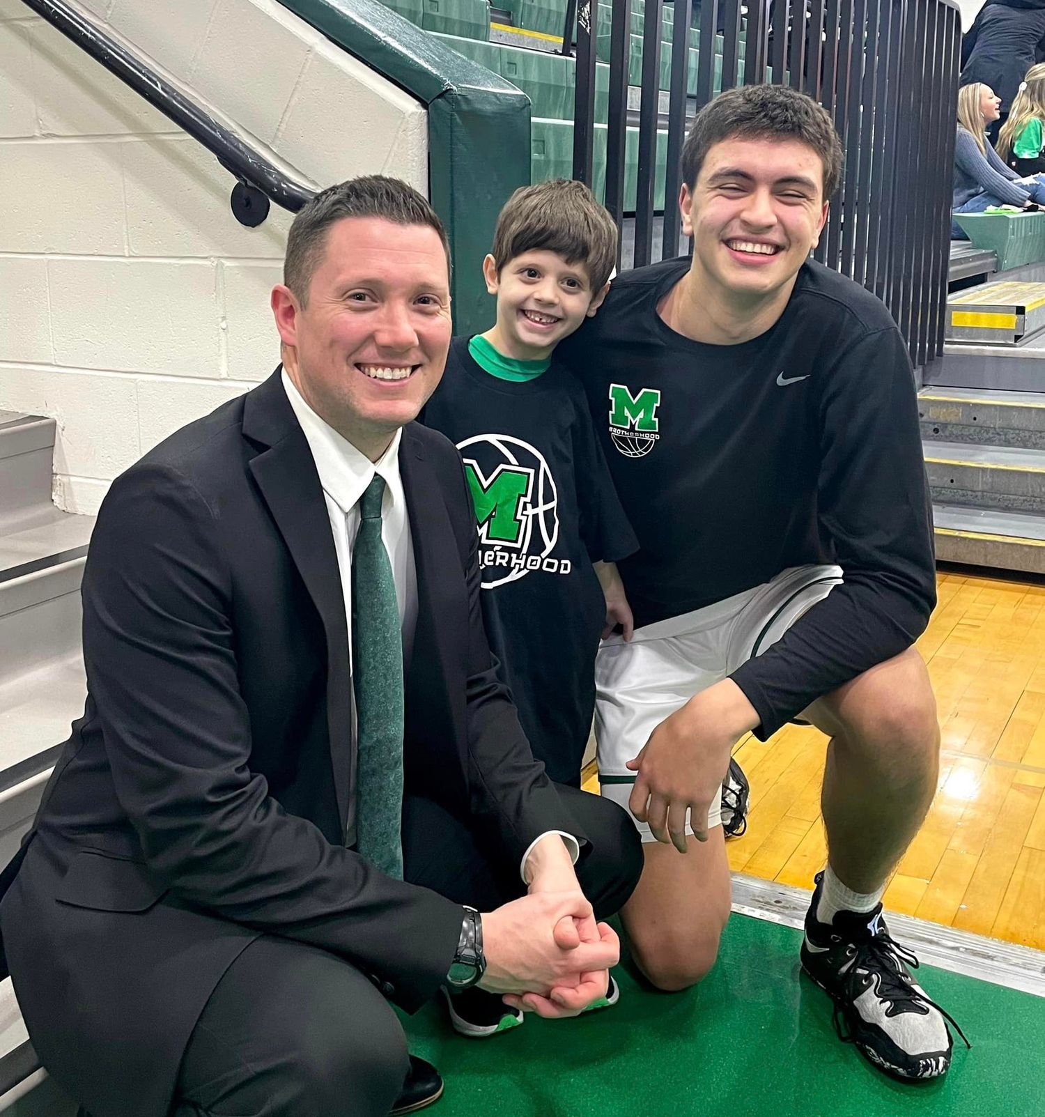 Christian posing with MHS basketball player and coach