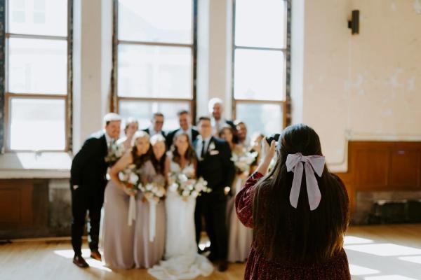 Photographer taking picture of group at wedding