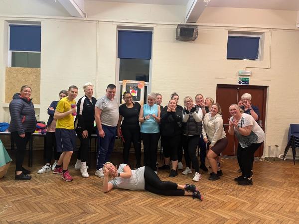 Sheryls warriors training group posing for a picture in a room.