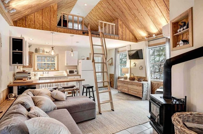 a living room with a couch and a wood stove