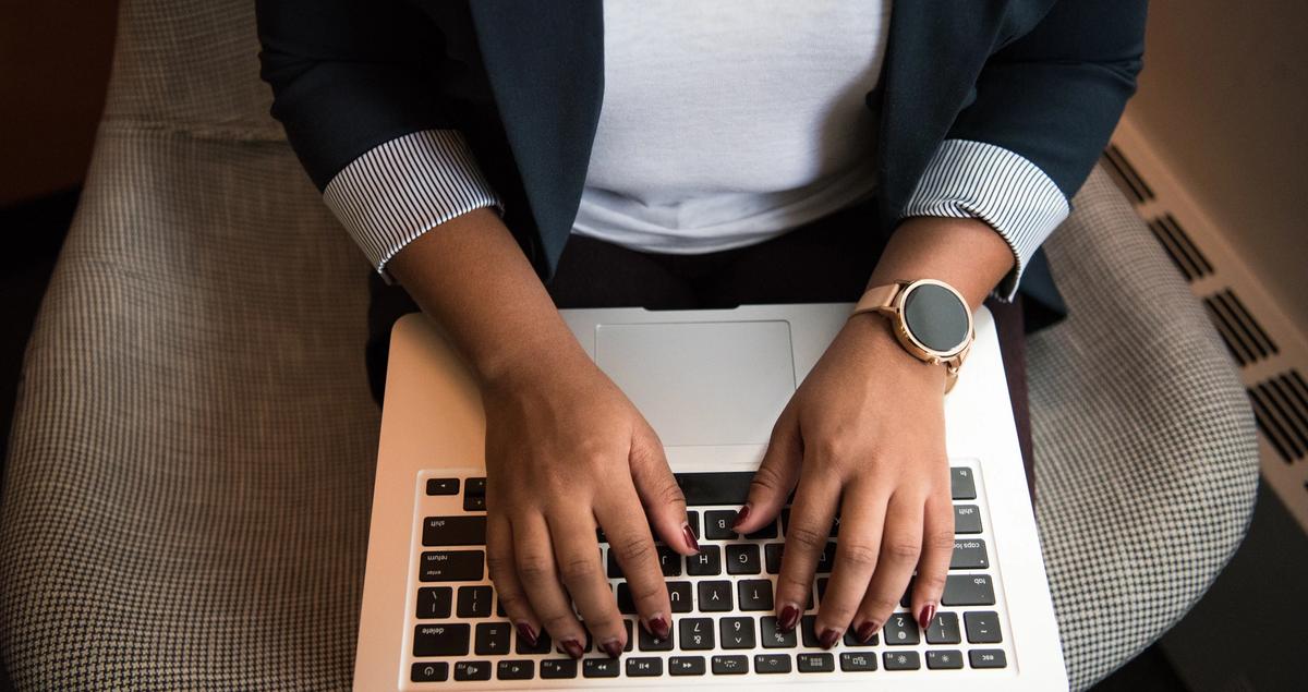 Person sending out an email on a laptop