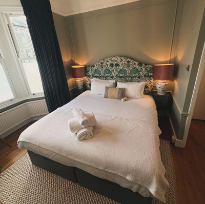 a bedroom with a bed and two lamps