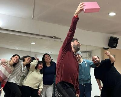 a group of people are posing for a picture in a dance studio .