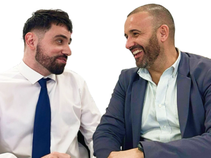 two men in suits and ties are laughing together