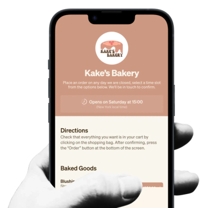 a hand is holding a phone that says kake 's bakery on the screen