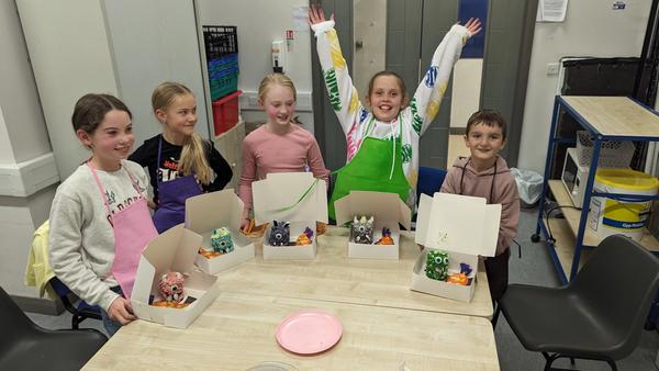 Young chefs showing off their baked goods