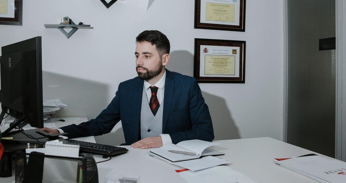 a man in a suit and tie with his arms crossed