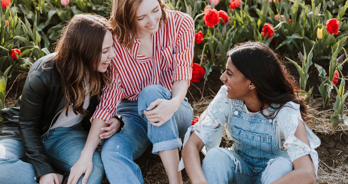 Group of three students sitting outside