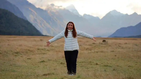 Woman standing in Eglington Valley in New Zealand