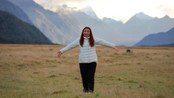 Woman standing in Eglington Valley in New Zealand