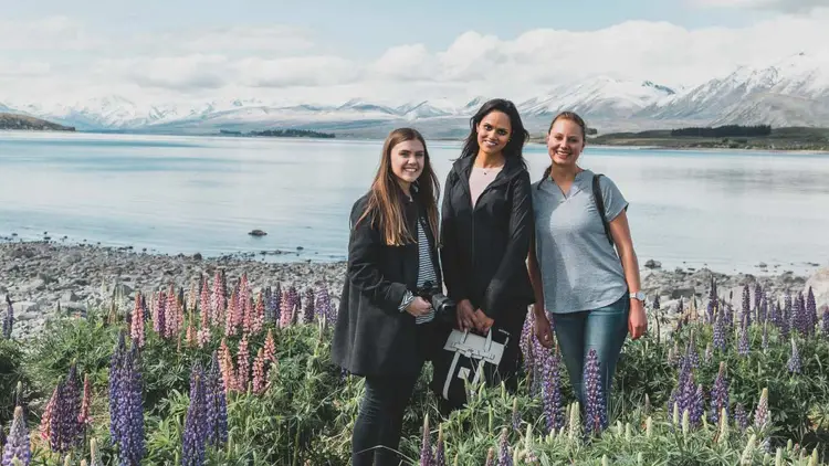 Group of people pose for a photo at Lake Tekapo