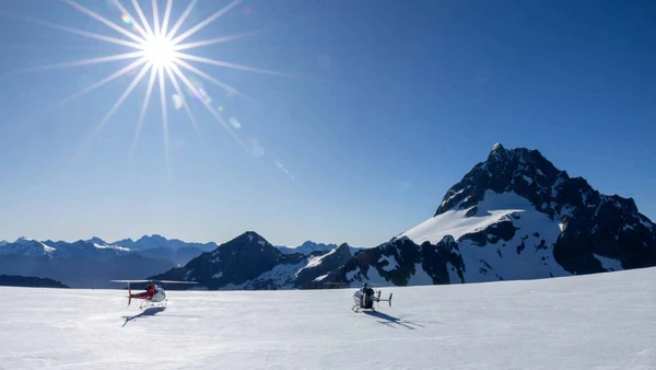 Two helicopters on a glacier landing in New Zealand