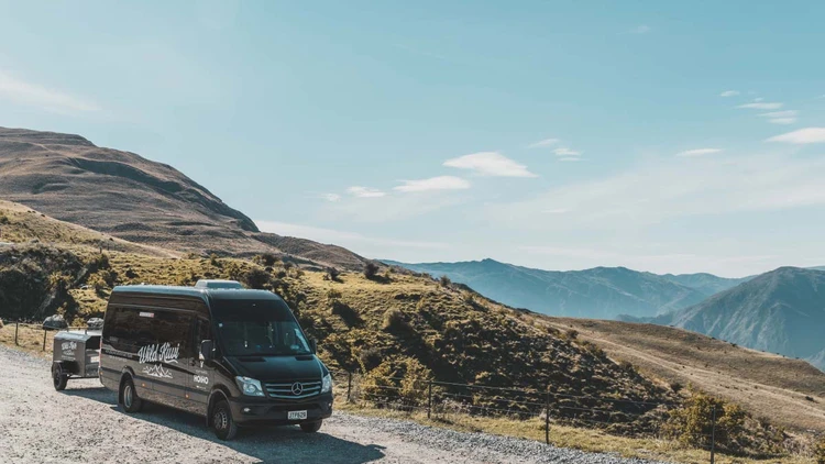 Wild Kiwi vehicle parked in front of some hills in the South Island